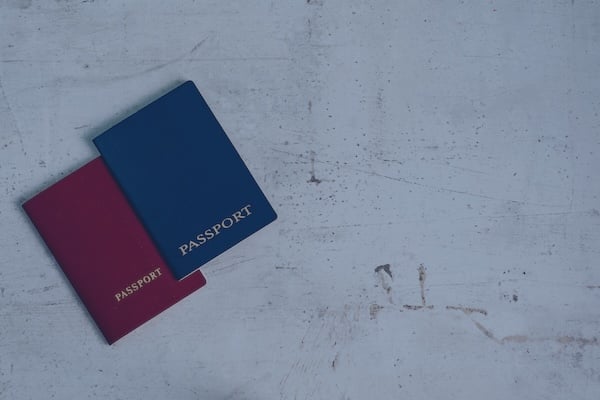 two-travelers-passports-red-blue-travel-concept