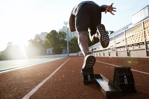 Runner taking off from the starting block-small
