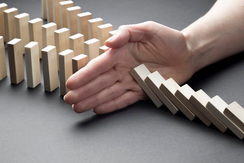 businessman-hand-stop-domino-continuous-tipping-risk-strategy-business