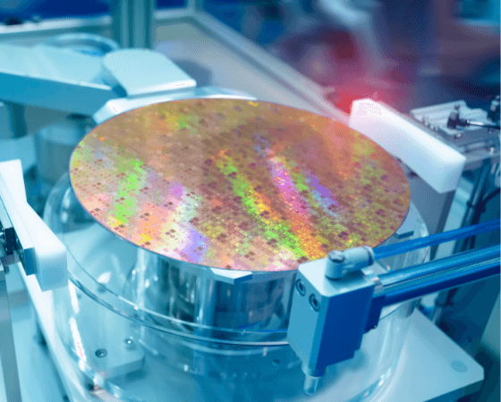 A reflective silicon wafer with colorful patterns on a semiconductor machine. A reflective silicon wafer with colorful patterns on a semiconductor machine.